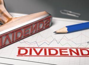 Rubber stamp with the word dividend printed over a stock chart.  Concept of investment. 3d illustration.